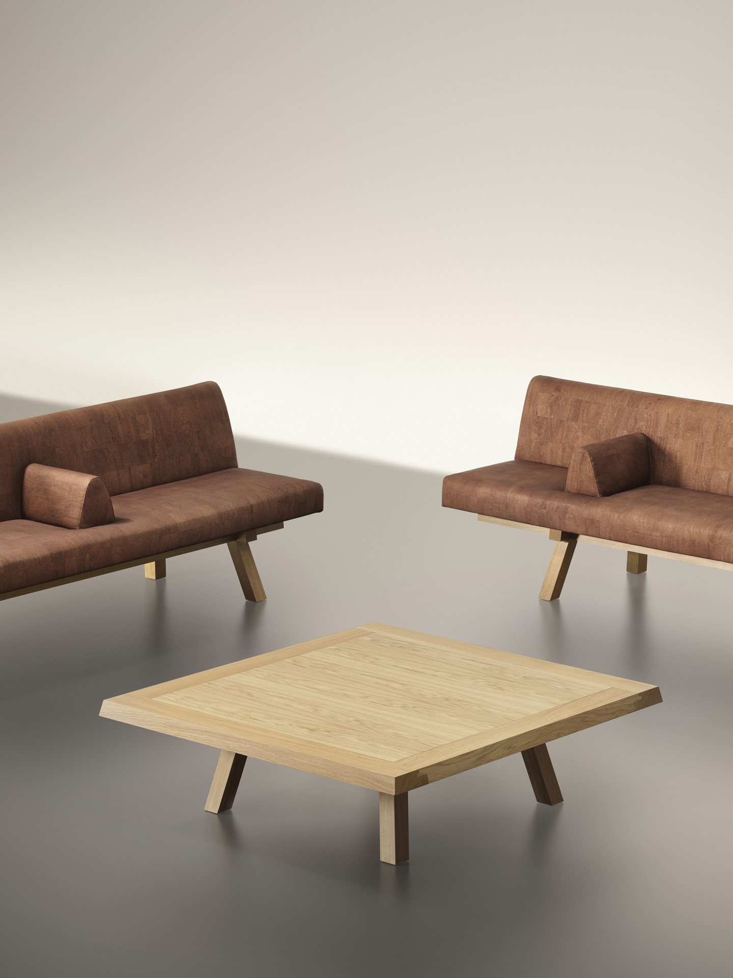In the foreground, square coffee table; in the background, cork-clad single-sided sofas | Ph. Alberto Strada