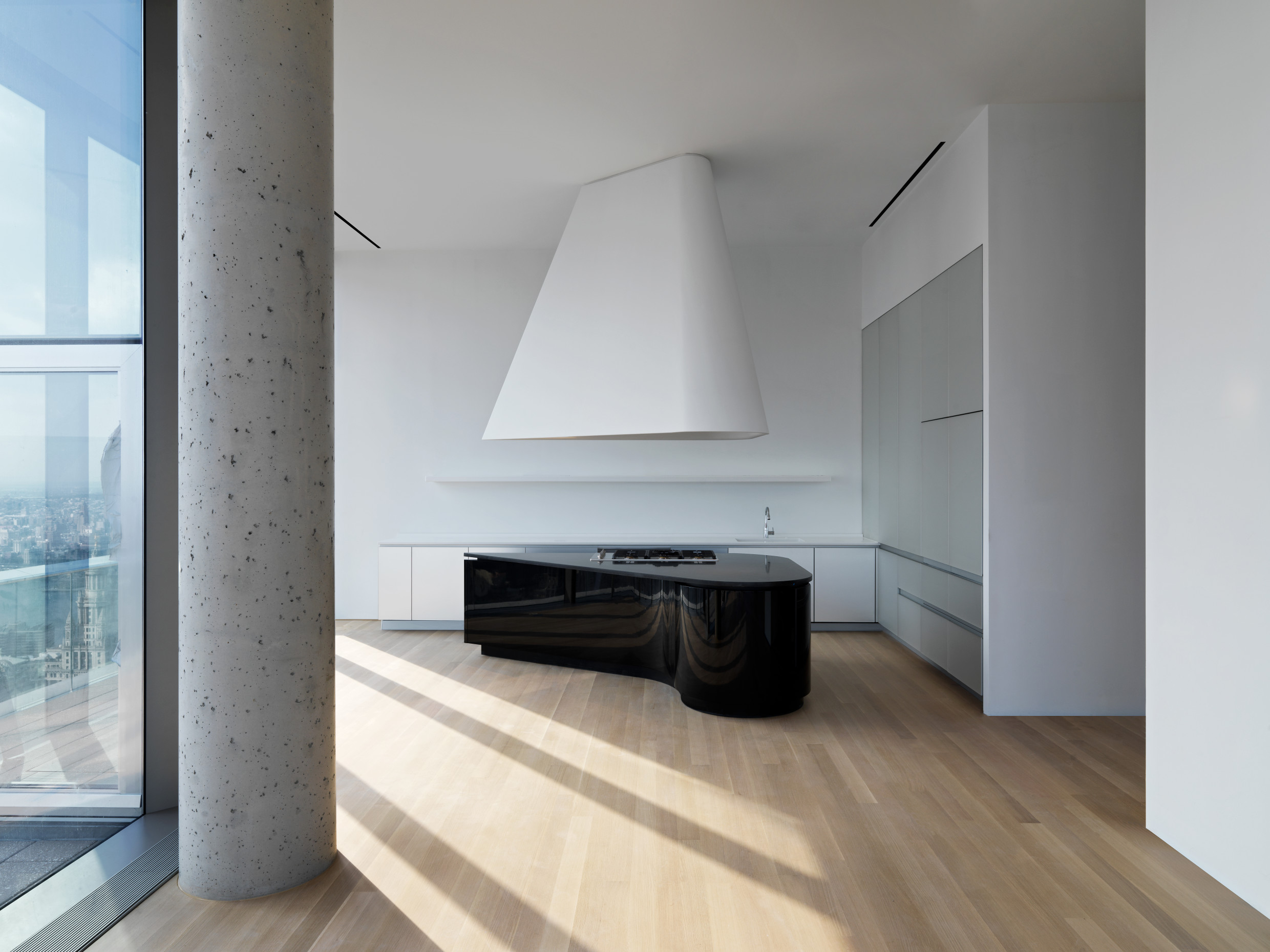 One of the custom-made kitchens at 56 Leonard Street in New York, based on a design by Herzog & de Meuron, featuring black islands with original granite countertops