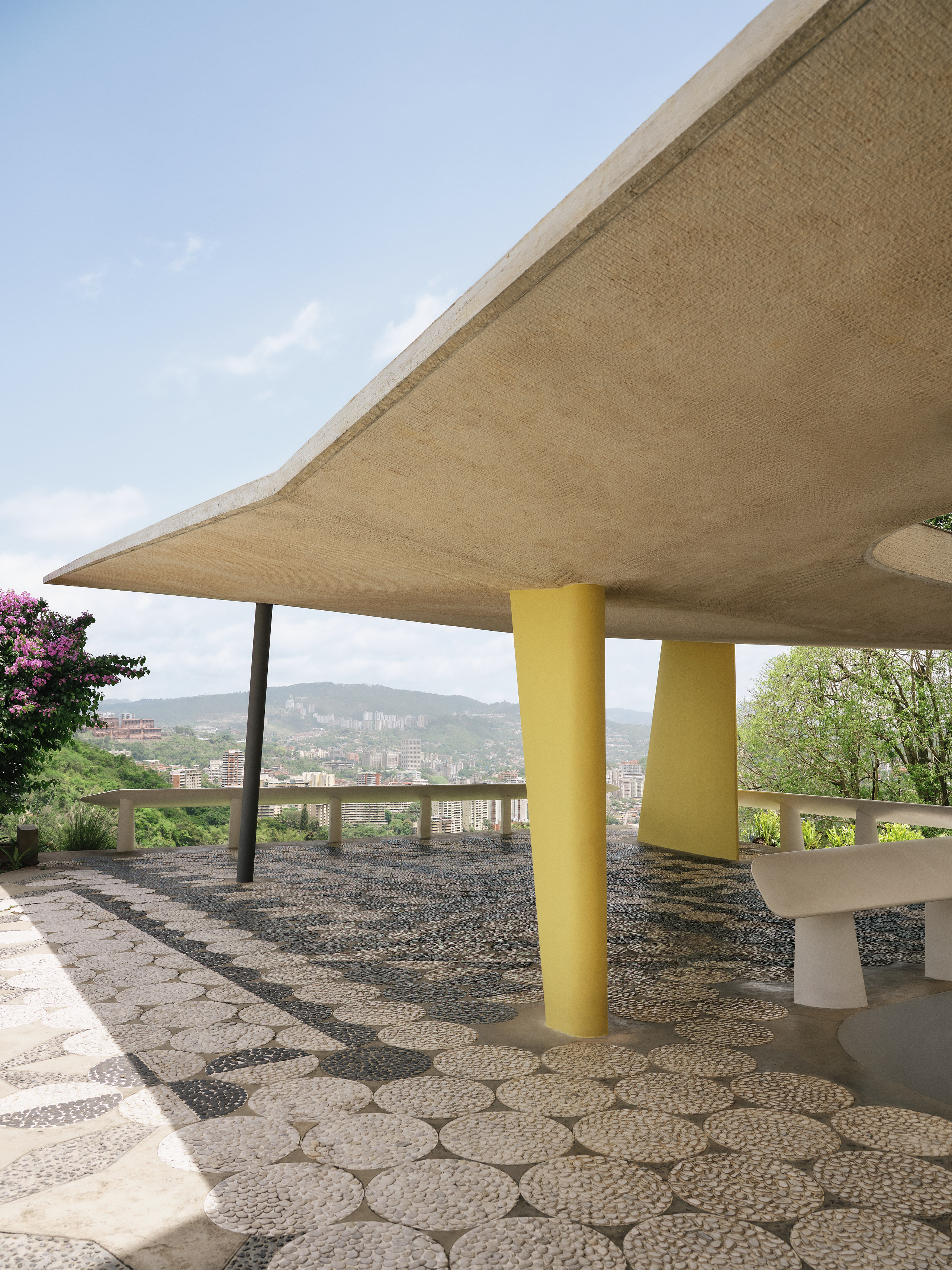 The butterfly shape is recurrent throughout the house and is also evoked by the roof of the carport