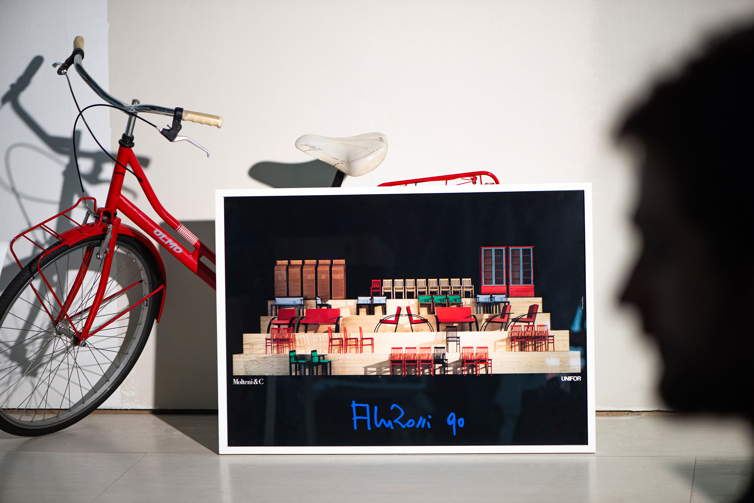 Manifesto, as installed at Salone del Mobile in 1990 showing Molteni&C and UniFor furniture by Aldo Rossi. Original photo by Mario Carrieri. Ph. Jeff Burton, from Molteni Mondo by Rizzoli NY, 2024